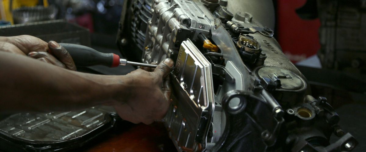 signs of transmission problems. Transmission fluid leak beneath a vehicle, indicating potential transmission problems.