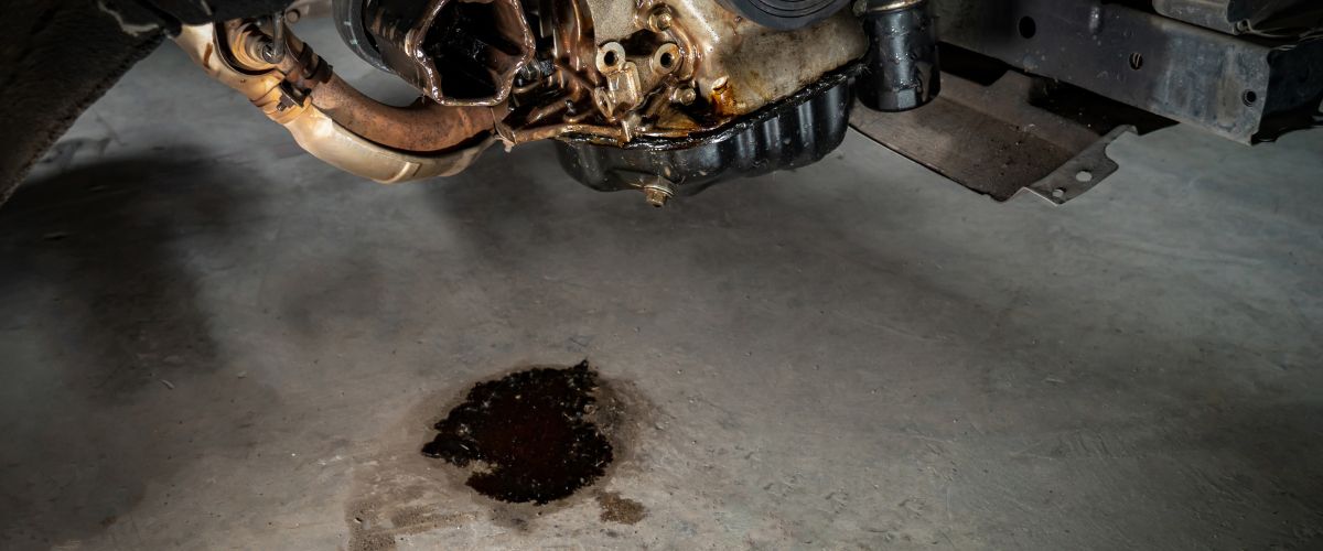 signs of transmission problems. Transmission fluid leak beneath a vehicle, indicating potential transmission problems.