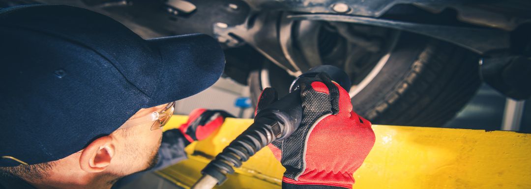 Automotive technician conducting seasonal vehicle inspections.