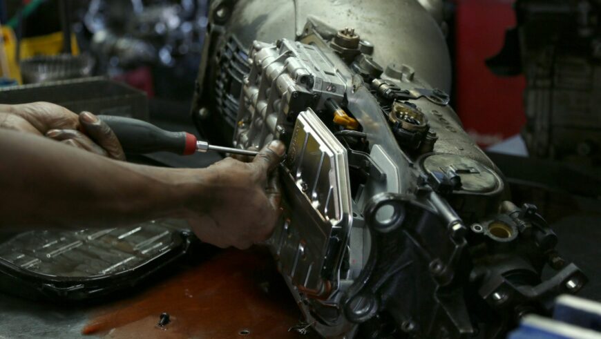 Mechanic repairing a vehicle transmission showing signs of slipping