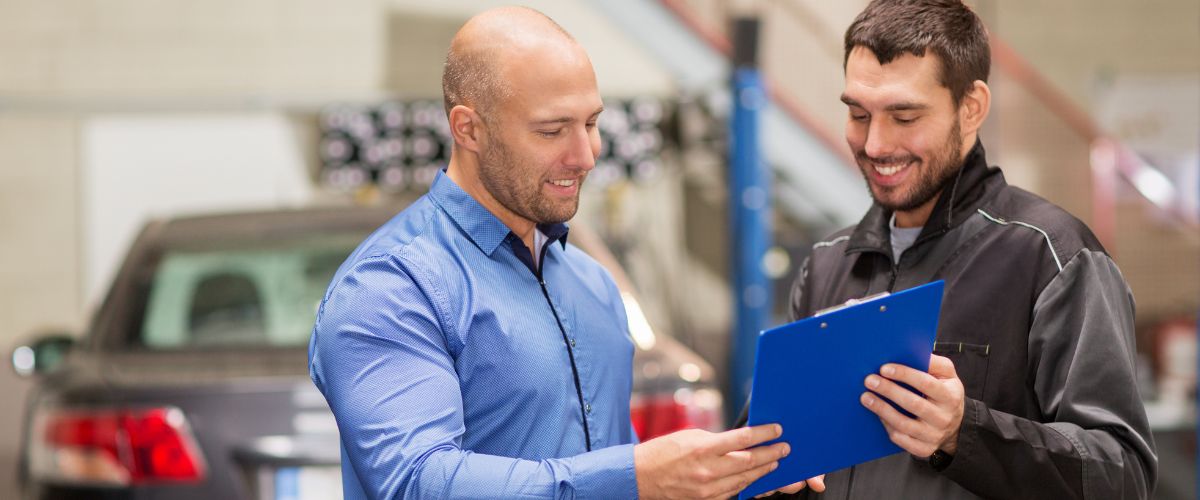 transmission rebuild vs transmission repair. Driver reviewing repair options with a technician after Signs of Transmission Failure. Title: