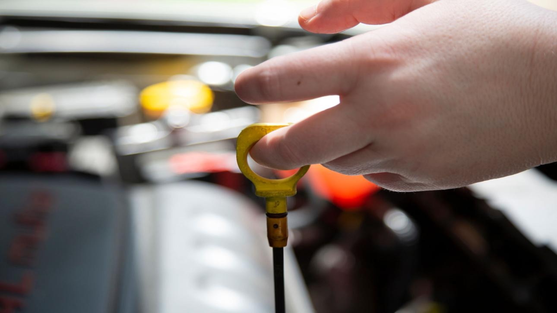 prevent transmission failure high mileage mechanic checking transmission fluid