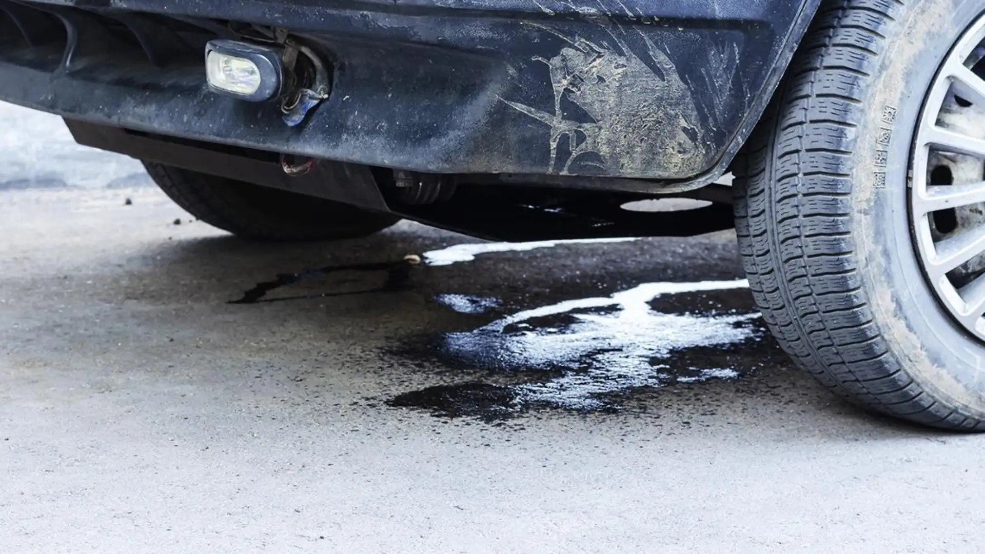 transmission leak under car red fluid puddle beneath vehicle